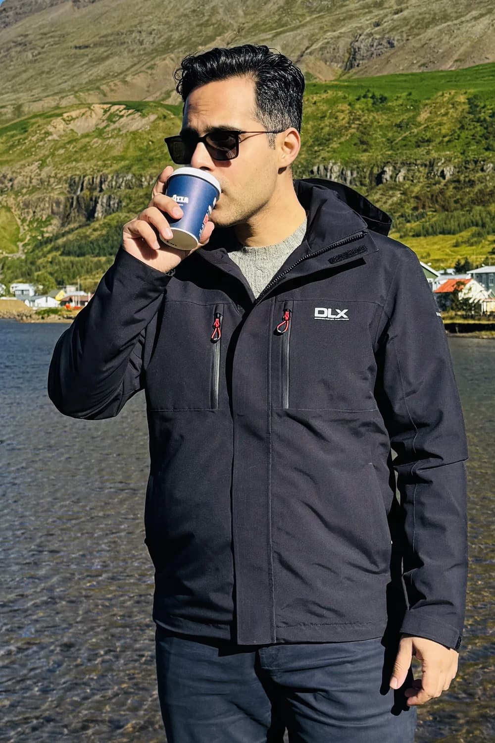 Bilal Aslam with a coffee by the fjord in Seyðisfjörður, Iceland